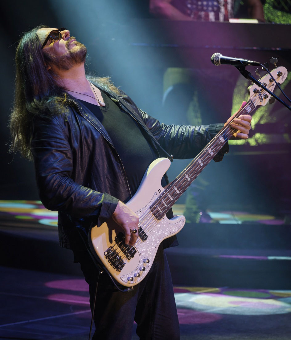 Kenny Lee Lewis leaning back playing bass with Steve Miller Band